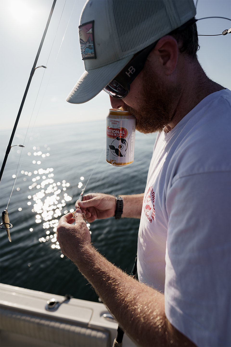 A fisherman rigging a rod.