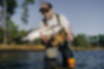 A wade fisherman holds a trophy speckled trout.