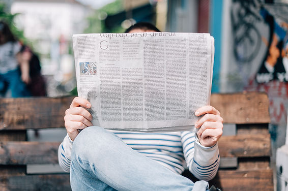 Person reading a newspaper.