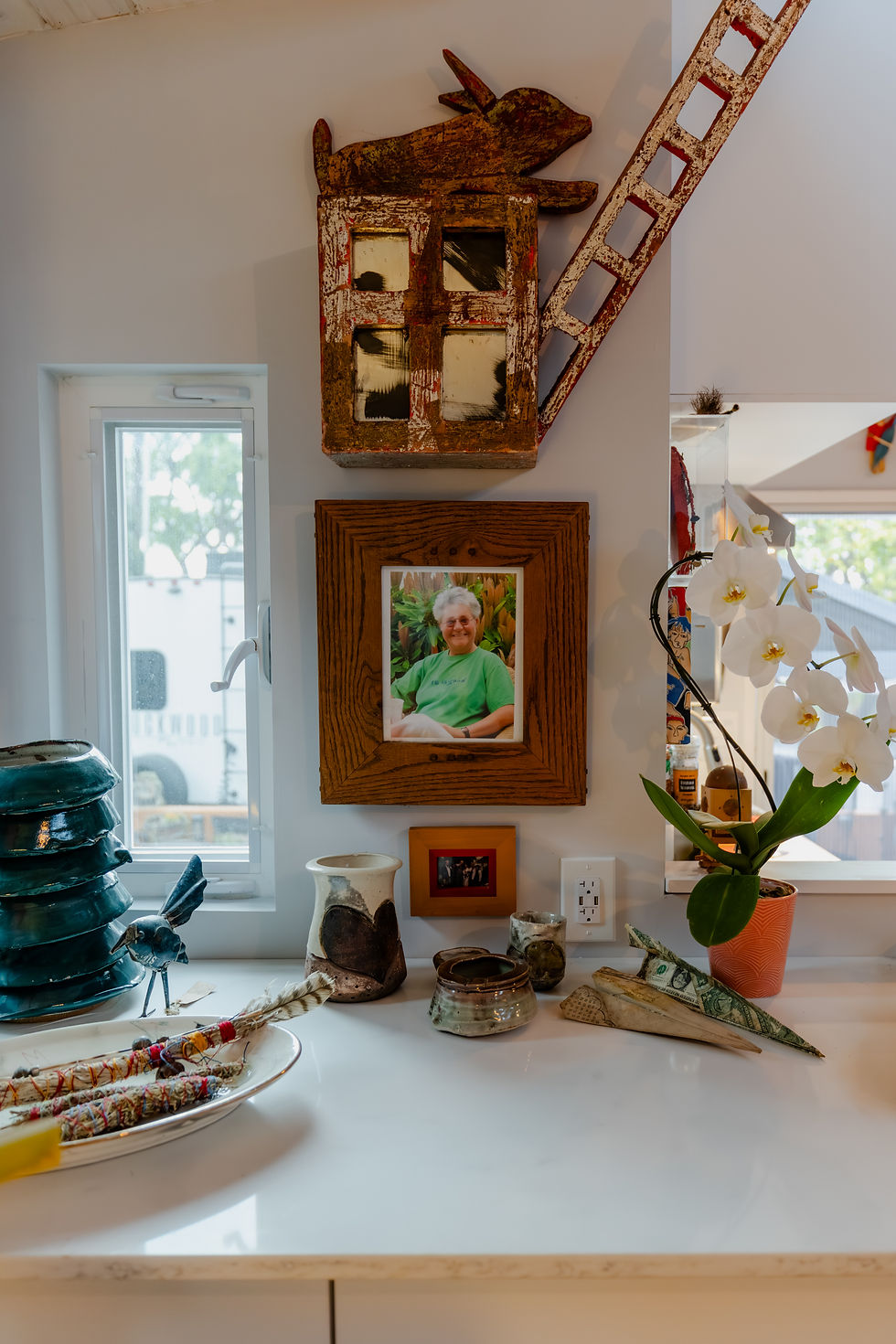 a tiny home bump-out corner filled with framed artwork
