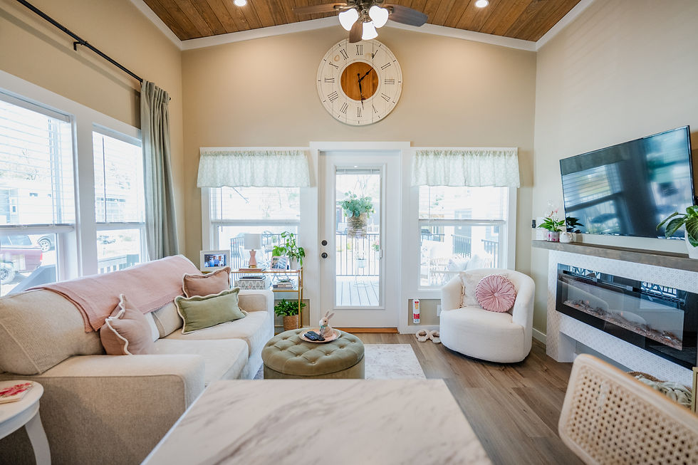 Tiny home living room with a stenciled electric fireplace, high ceilings and a love seat