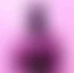Portrait of a South Sudanese model seated against a pink backdrop, wearing a pink outfit and holding a bouquet of purple flowers as part of an early attempt to bring the Afro ABCs concept into photographed form.