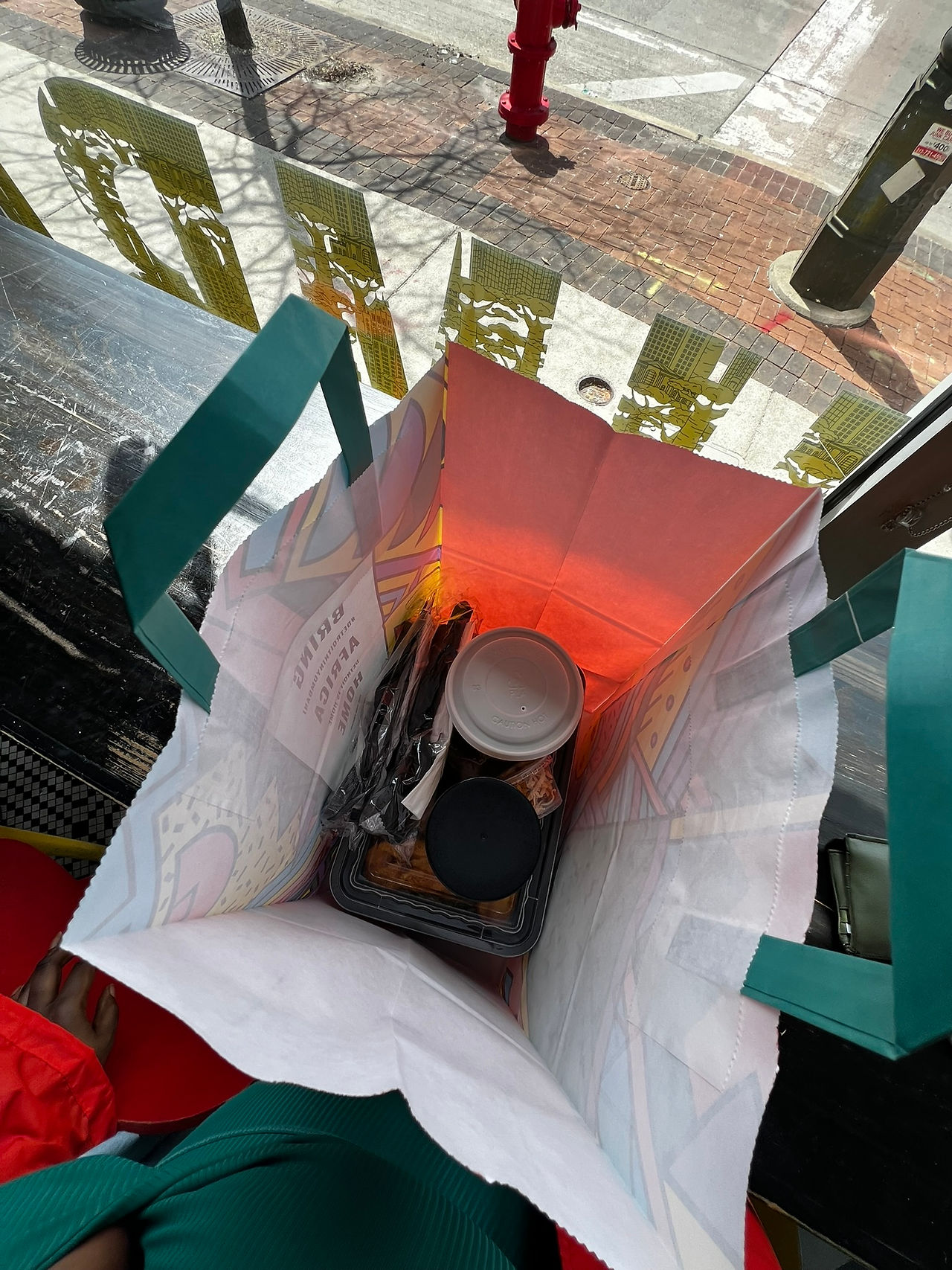 Overhead view of East African takeout from Baobab Fare, multiple dishes arranged in containers, a sp