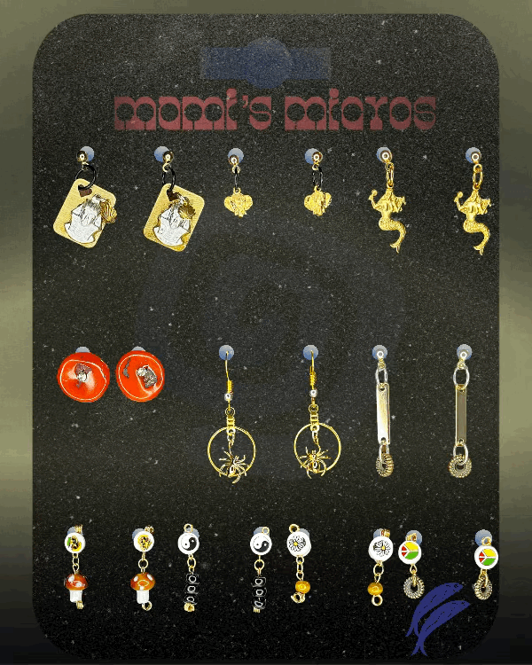 Rows of handmade gold, red, silver, and beaded earrings arranged on a black display board that reads “MAMI’S MICROS)