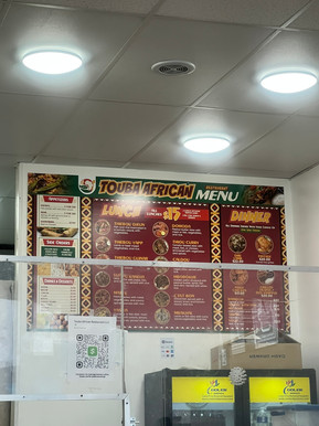 Menu from Touba African Restaurant, listing dishes that trace across the African diaspora through fl