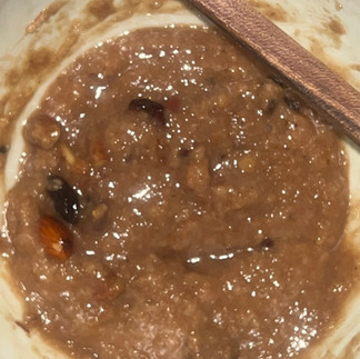 A bowl of porridge naturally forming a smile-like shape, creating an unintentional face that suggests synchronicity and encouragement.