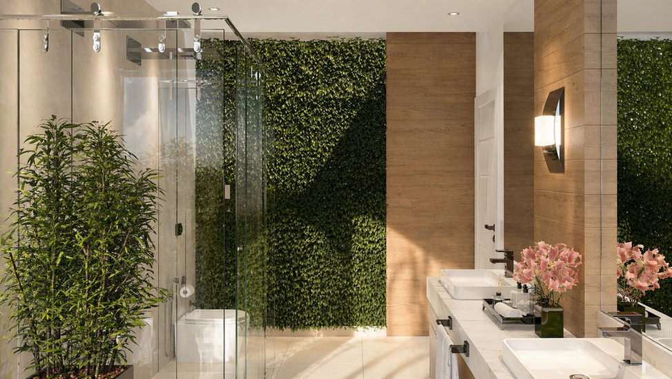 Banheiro contemporâneo com layout contínuo e setorização sutil entre área seca e molhada, usando divisórias transparentes que mantêm integração visual e facilitam circulação e manutenção. Materiais claros com textura natural ampliam a luminosidade e reforçam sensação de limpeza e conforto. Bancada funcional com ergonomia e organização visual. Presença de vegetação e entrada de luz natural melhoram o microclima e o bem-estar. Iluminação em camadas valoriza volumes e permite ajustar a ambiência conforme o uso.