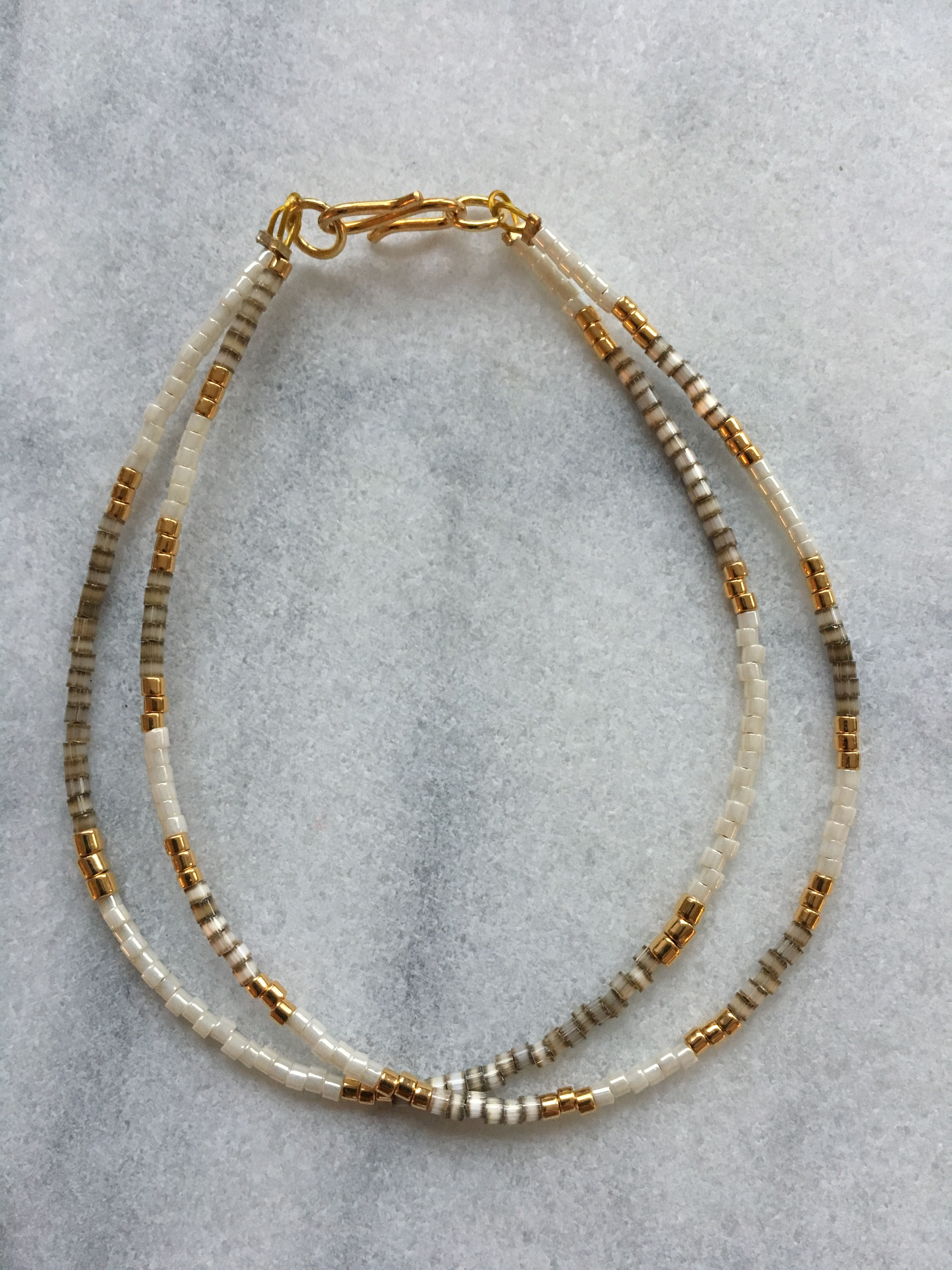 Beige, gold and white 2 string bracelet