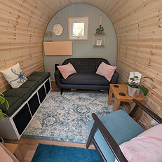 Image shows the comfortable and confidential space inside the garden pod in Winchcombe near Cheltenham where Wanderwood Coaching offers in person or online coaching sessions for adults across a range of topics including neurodivergence, ADHD, autism, diagnosis, reasonable adjustments at work, lifestyle, life transitions such as divorce and separation or relocation, families including blended families, single parenting and co-parenting, corporate careers, career changes and work life balance.