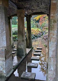 Image shows stepping stones in water under a bridge at a location near Winchcombe, Cheltenham, where Wanderwood Coaching offers sessions for adults in person or online to provide support in relation to lifestyle or transitions. The stepping stones and view through the bridge represent the steps or challenges along the way, whatever event they are facing, including relocation, marriage, divorce, separation, parenthood, retirement, etc.