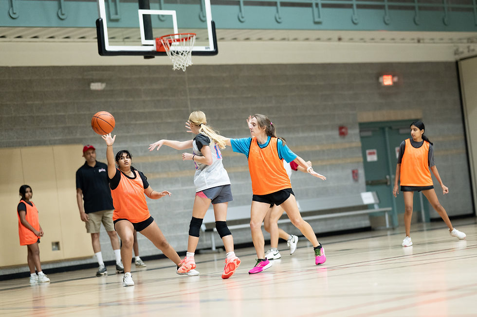 Close-up view of hands passing a basketball during a girls youth practice.