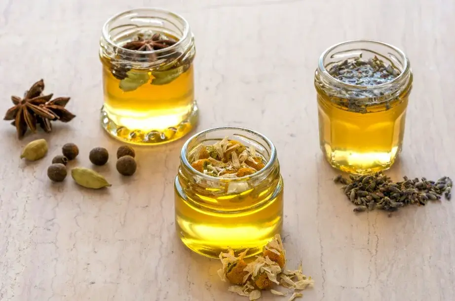 Jars of honey infused with star anise, cardamom, and herbs