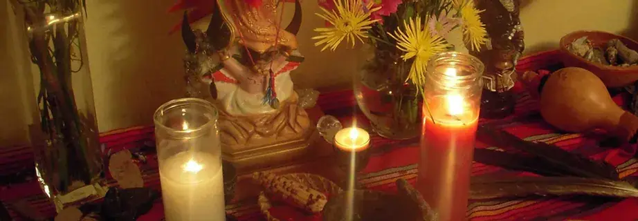 Close-up view of traditional herbs and candles used in Curanderismo rituals