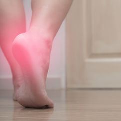 Closeup of female right foot heel pain, with red spot, plantar fasciitis.jpg