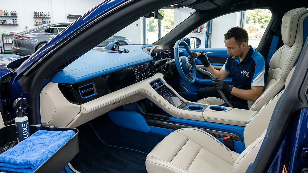 Eye-level view of a luxury car interior being cleaned and detailed
