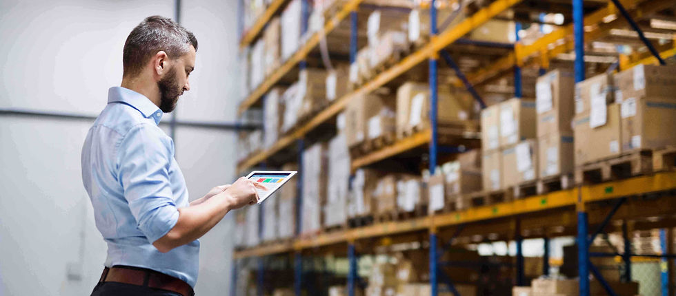 Man checking stock in a warehouse, warehouse with lots of boxed medical equipment 