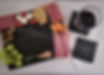 Image of engraved business logo slate charcuterie board and coasters with food on charcuterie board, glass on coaster