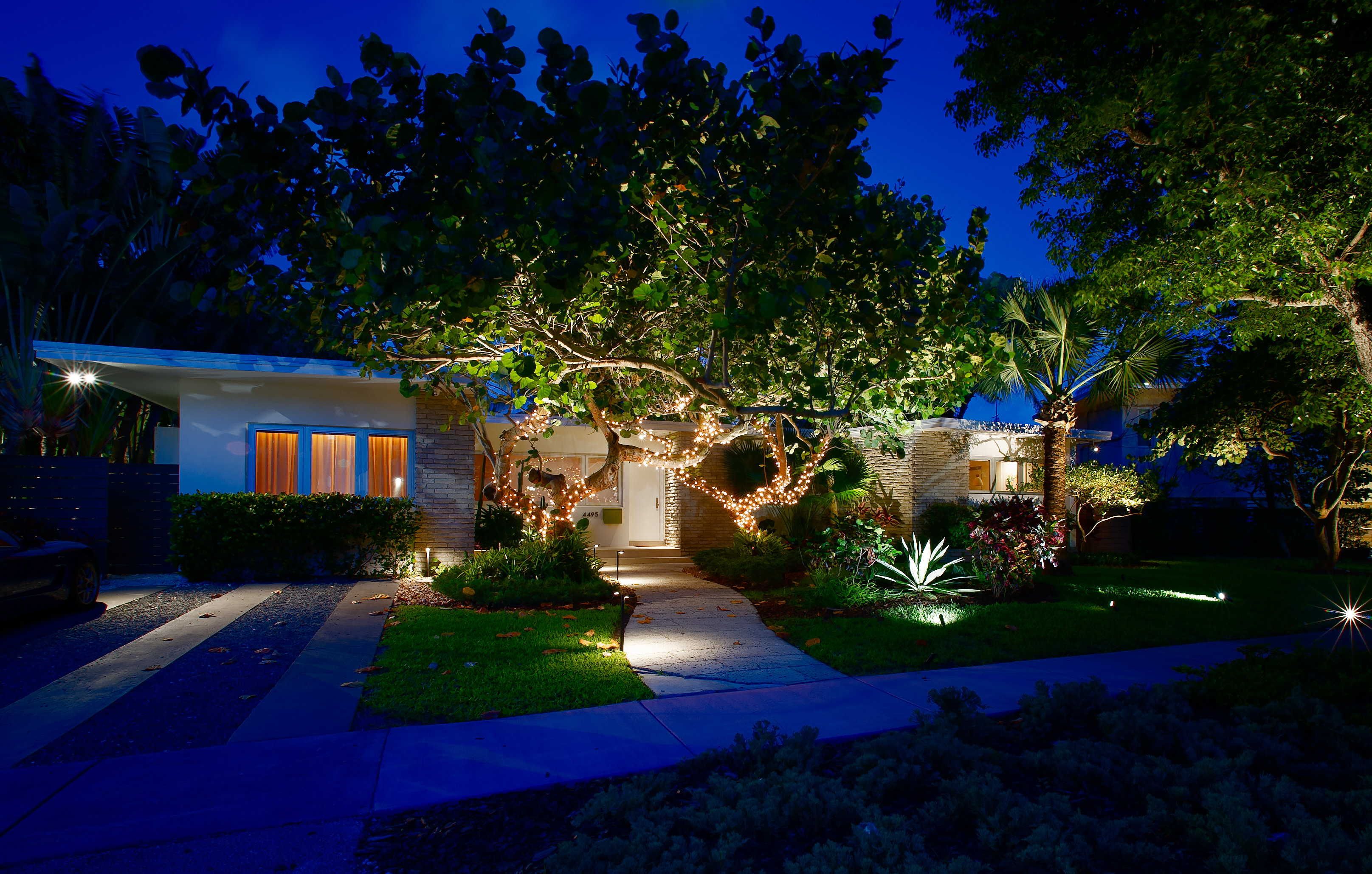 Noble path lights and directional fixtures illuminating a residential landscape