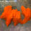 Thumbnail: Small bright orange solid hen feathers for crafts