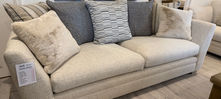 Modern beige fabric sofa with decorative cushions showroom