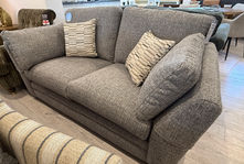 Grey fabric two-seater sofa with striped accent pillows