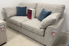 Beige textured fabric sofa with blue cushions on sale