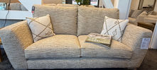 Textured tan two-seater sofa with patterned cushions