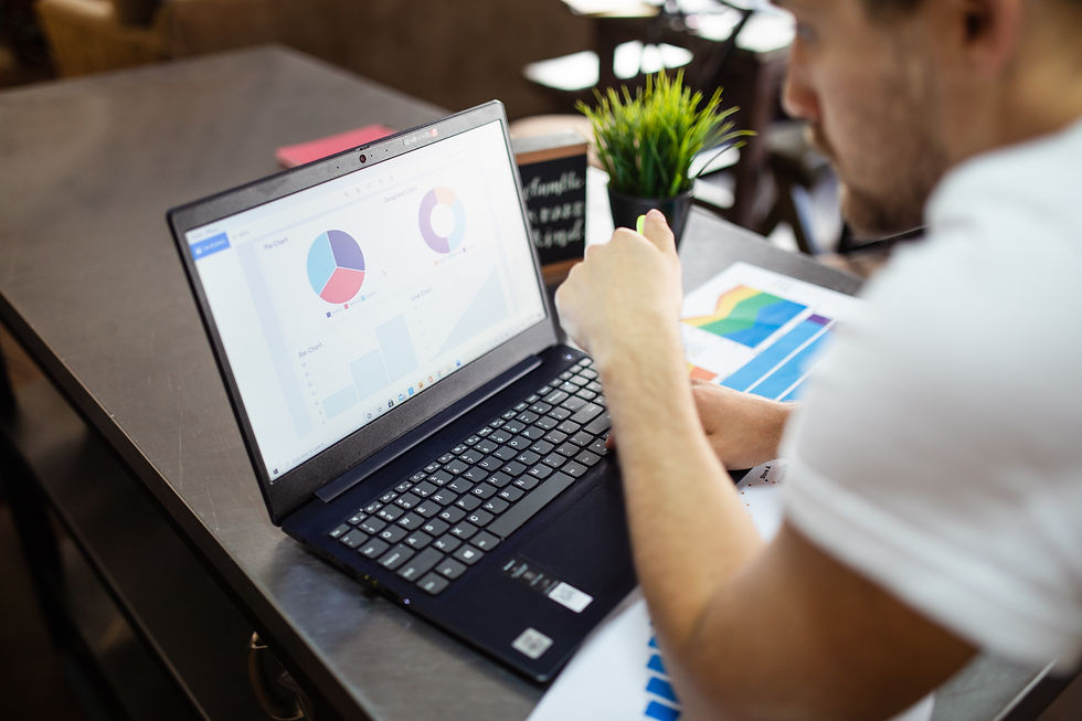 Man analyzing sales growth charts on laptop