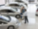 Couple with sales representative looking at cars
