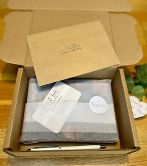 Gift-ready stationery box with tissue-wrapped notebook and thoughtful paper goods under £20