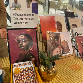 A market stall displaying African themed illustrations in prints and cards.