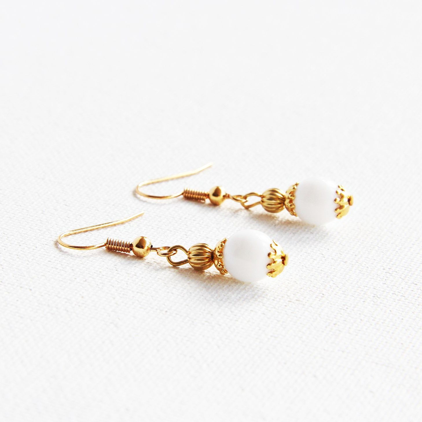 Opaque white beaded with gold earrings