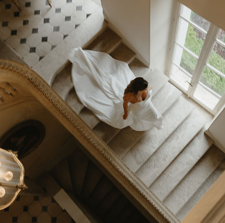 Bride walking down château steps
