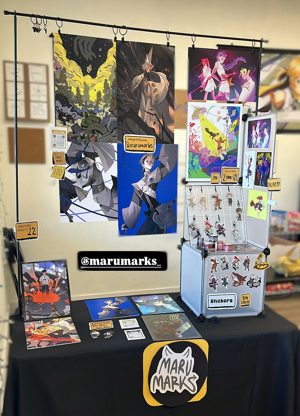 Marci brought in her famous Gachiakuta and The Summer Hikaru Died prints, keychains, and stickers, and some of her newer pieces, including some prints for Witch Hat Atelier.