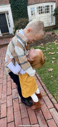 Watty and Lila hug in fall clothes.JPG