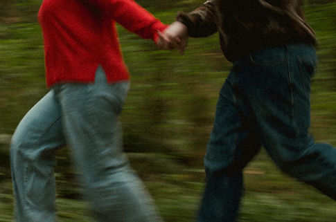 Couple running through the forest