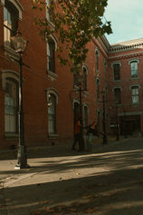Couple spinning around a lamppost in downtown Victoria