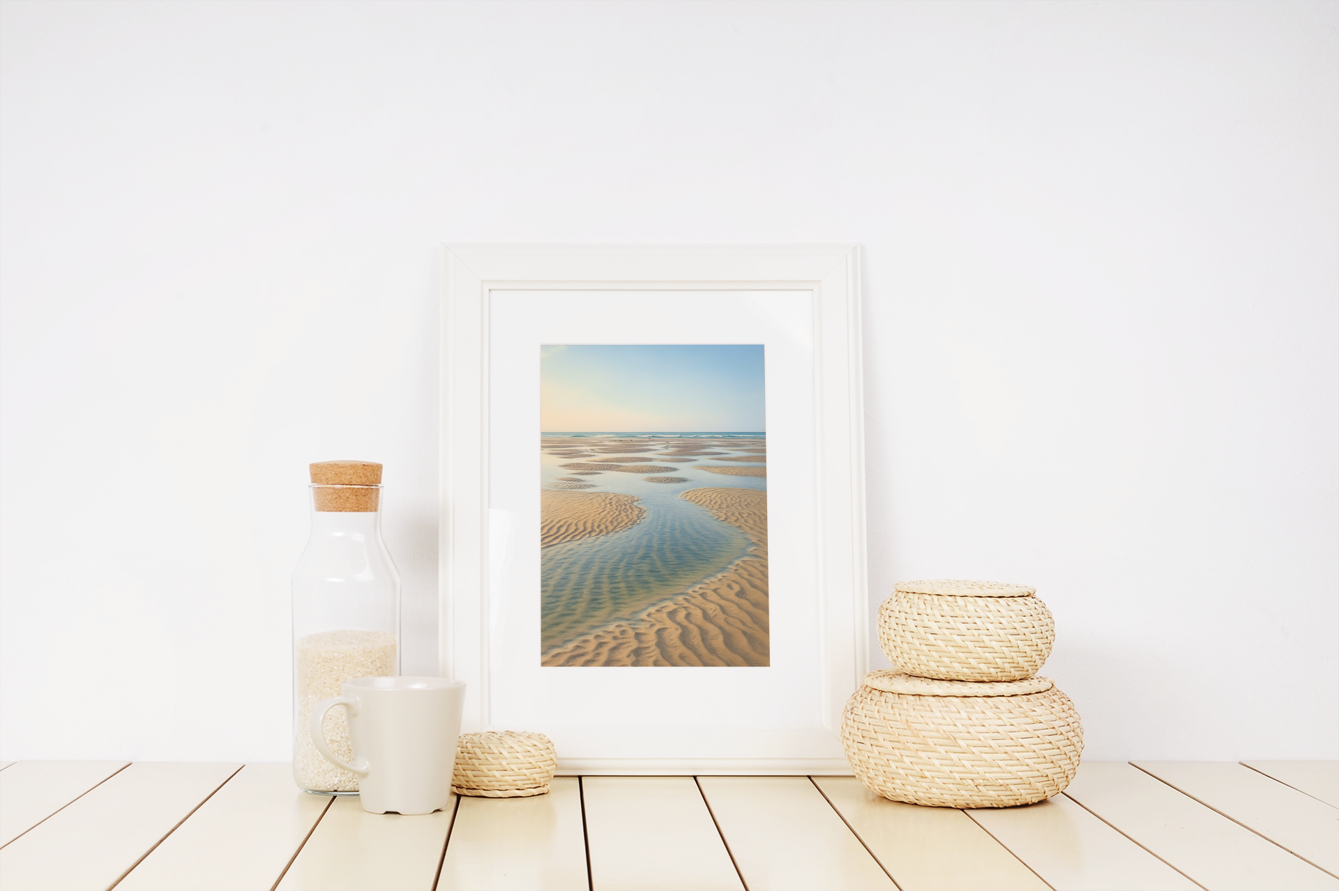 Framed coastal sandbar print with beach decor on white shelf