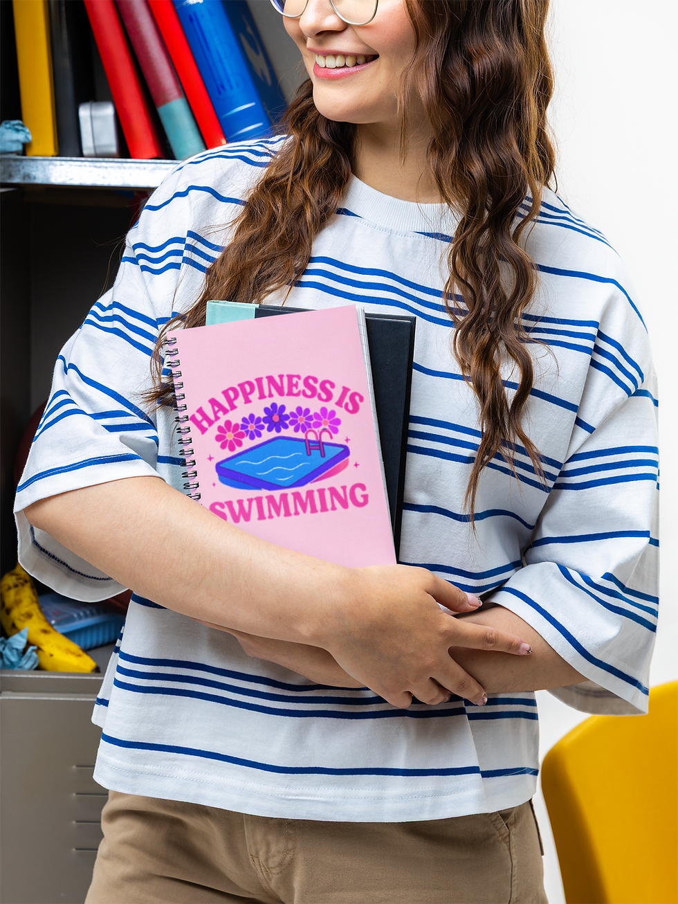 Thumbnail: Young woman holding Happiness Is Swimming spiral swim planner lifestyle mockup