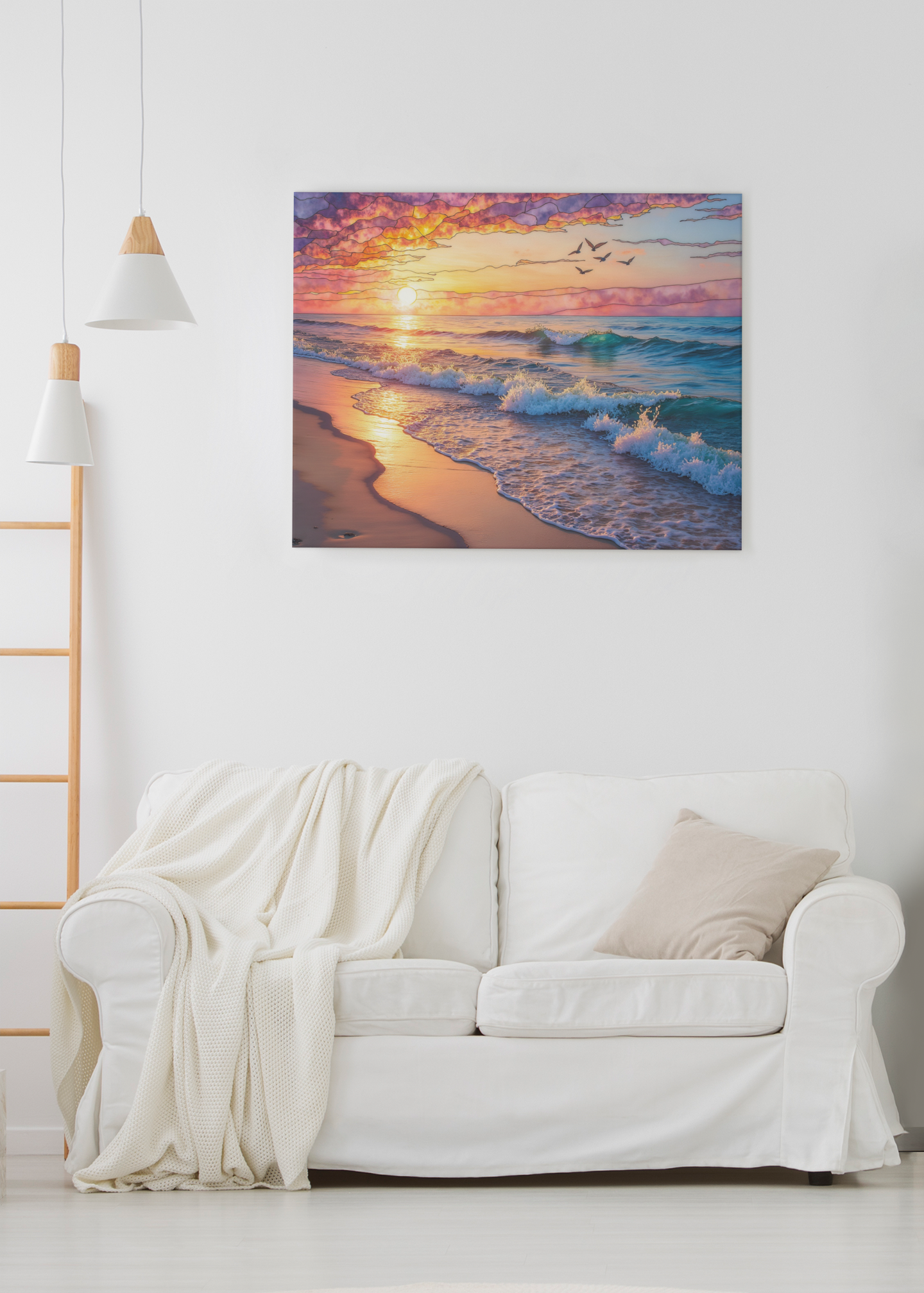 Framed vibrant sunset beach print displayed above a white couch with blankets