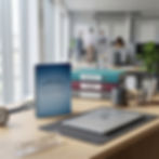 Blue one-on-one meeting notebook on desk with laptop and office workspace setup
