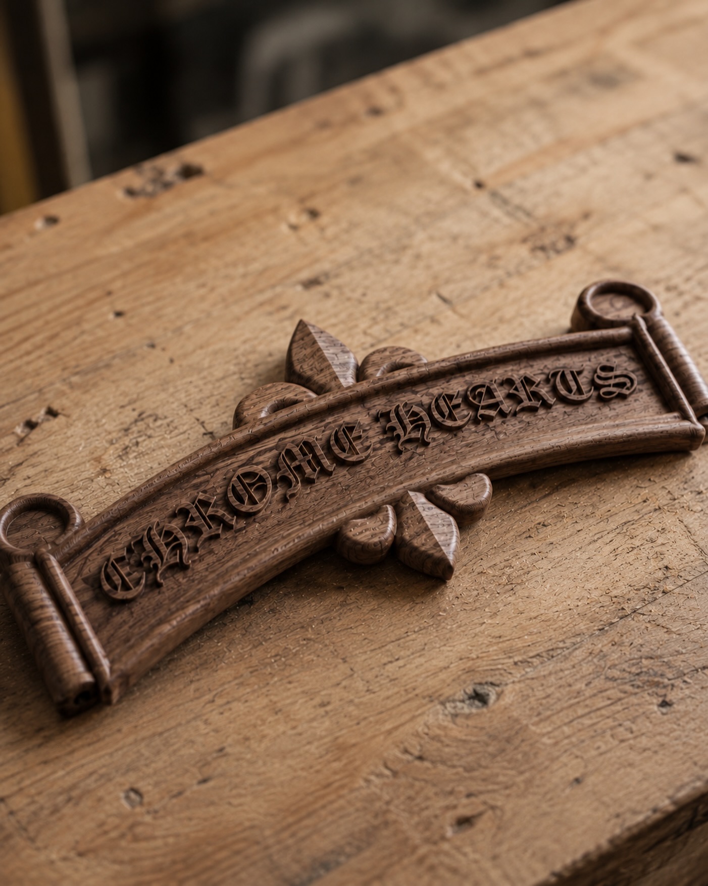 Ornate carved wooden plaque on a workshop bench