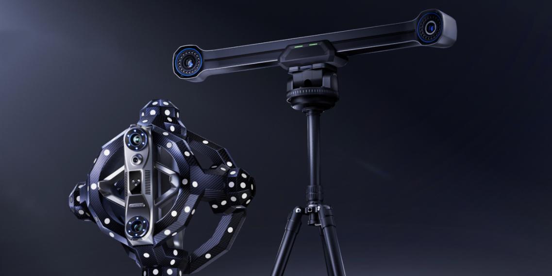 Handheld 3D scanner with tracking markers beside a tripod-mounted optical tracking system