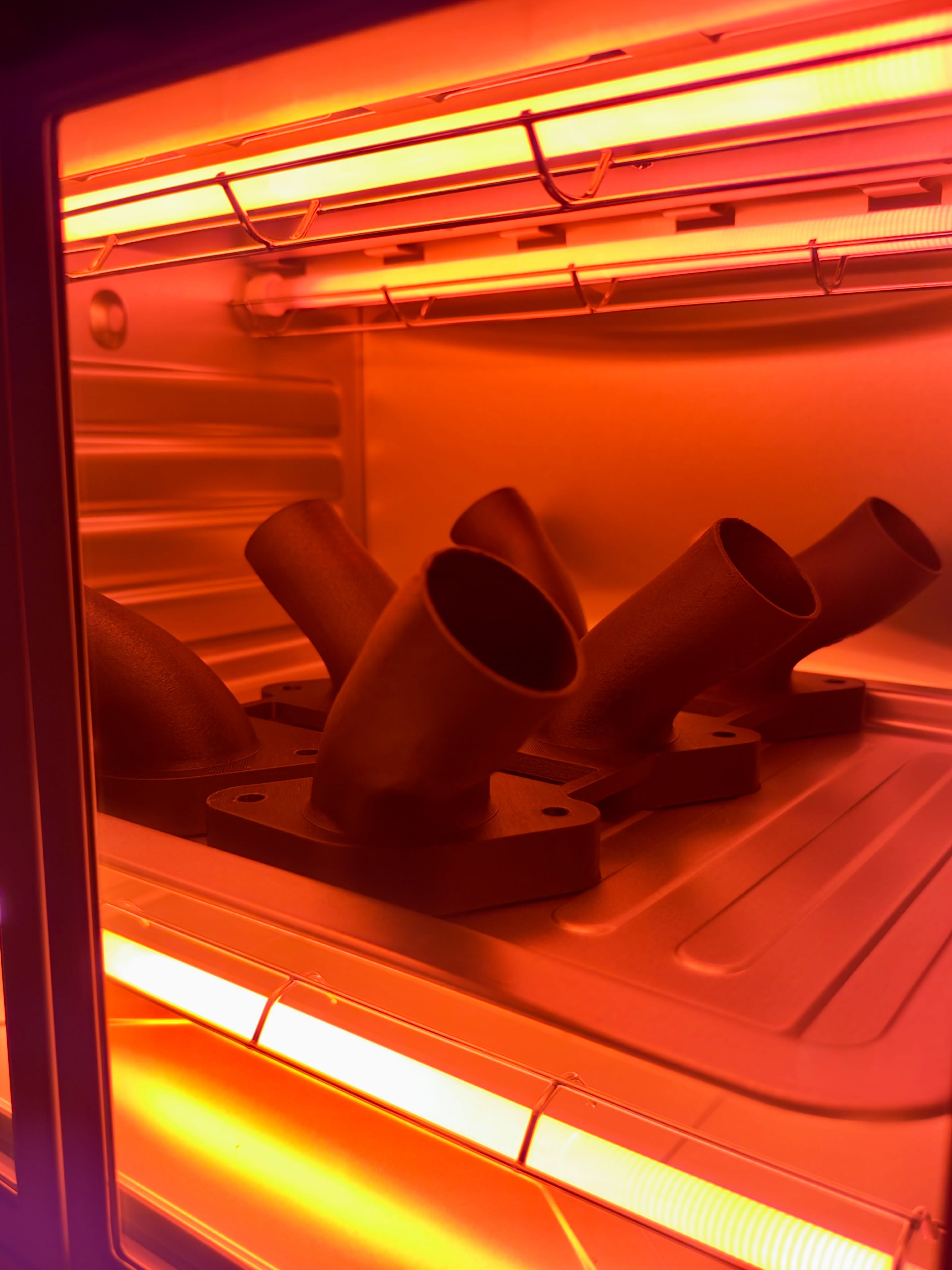 Carbon-fiber reinforced printed components inside a glowing annealing oven