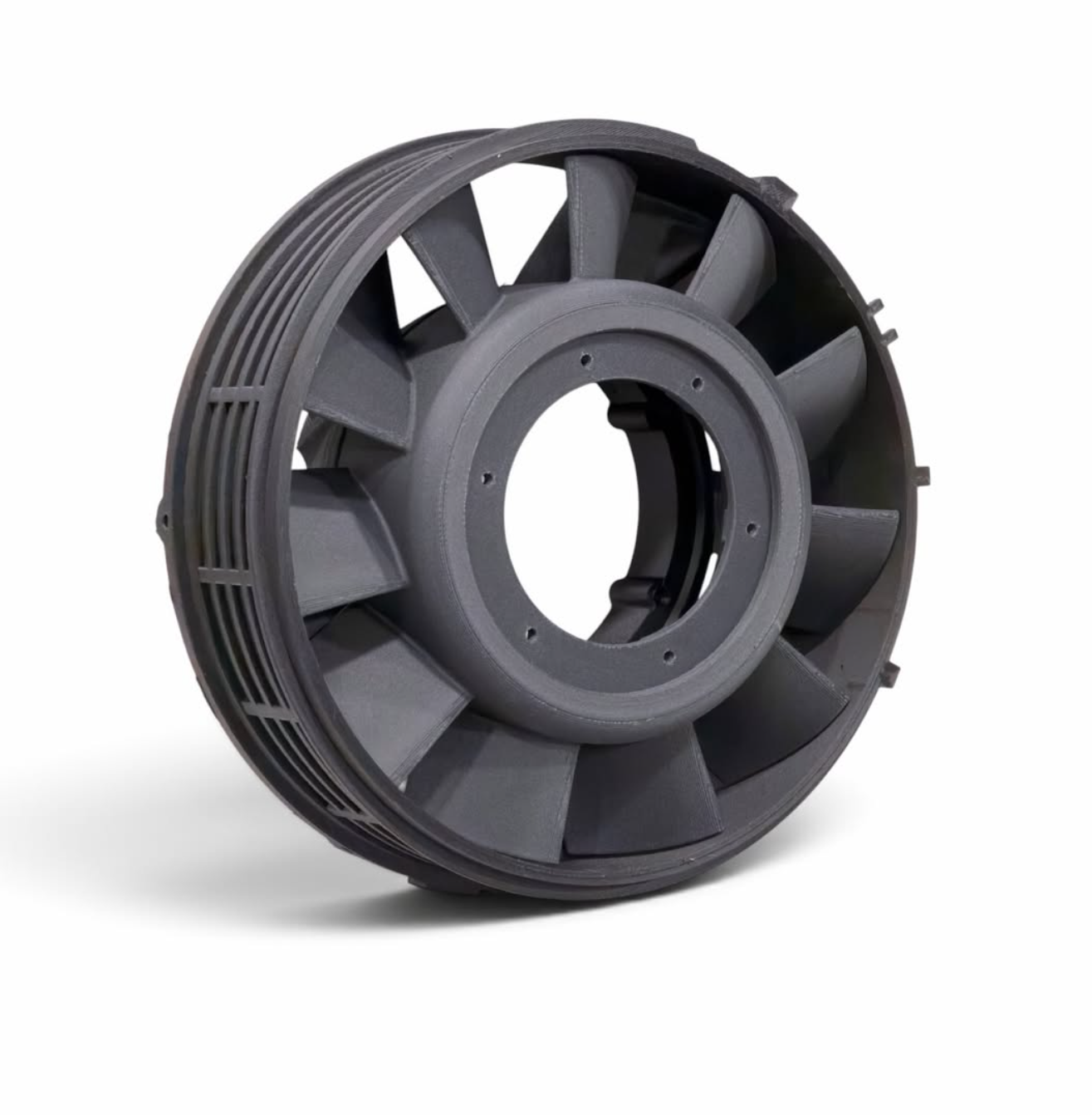 Dark FDM printed circular component with radial ribs, a central opening and mounting holes on a white background