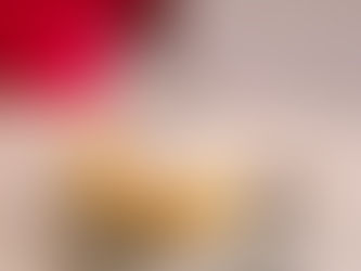 A plate of fluffy pancakes served with powder sugar and blueberries.