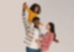 Father with daugher on his shoulders and mother smiling