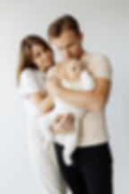 mother and father holding baby