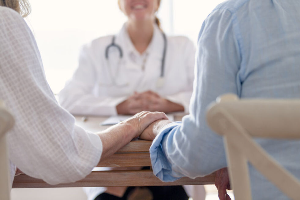 couple holding hands at doctor's office