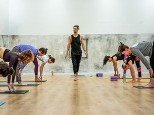 Yoga teacher training students practicing together in studio and online